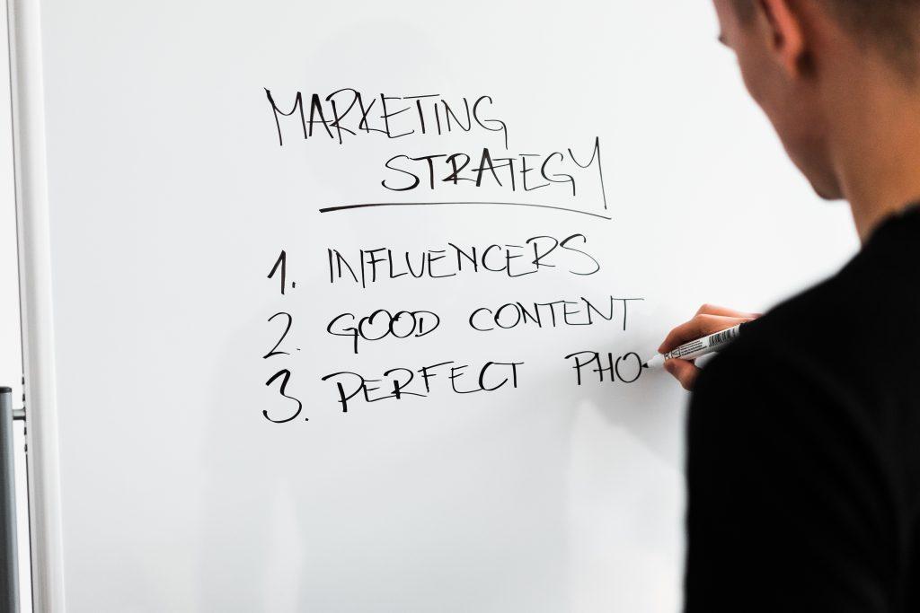 Marketing-expert-writing-new-marketing-strategy-on-whiteboard